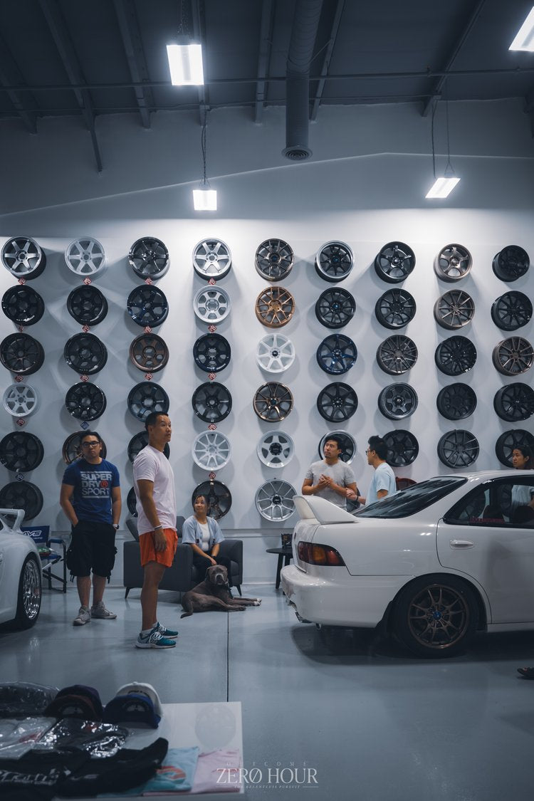 Enthusiasts at a customer meet in front of the Speed Factor Calgary wheel wall