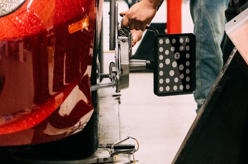Close-up of a red car front wheel in the service bay