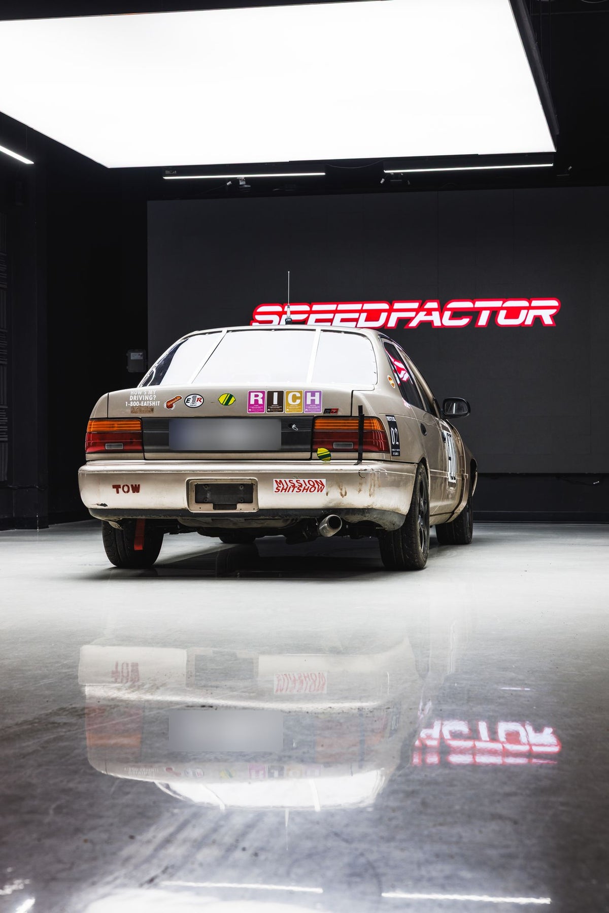 Rear of the Lemons Corolla with Mission Shitshow sticker under the Speed Factor sign