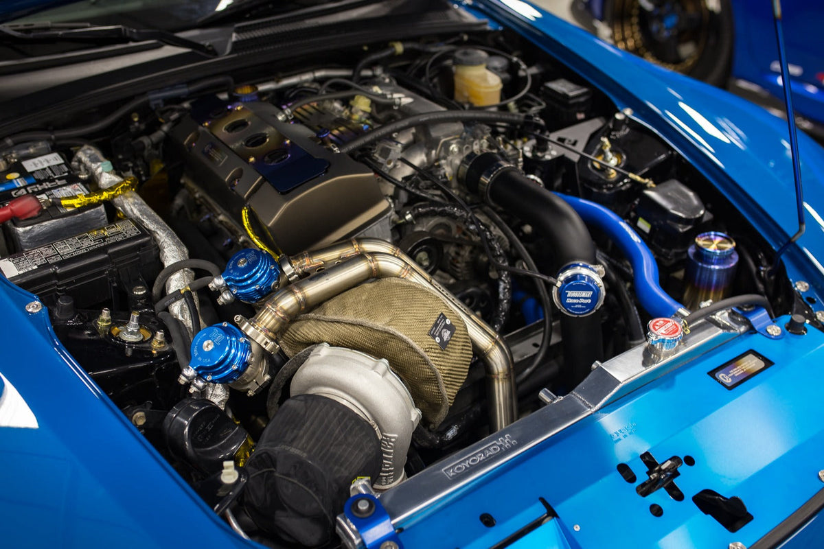 Turbocharged engine bay with polished intake and blue hardware
