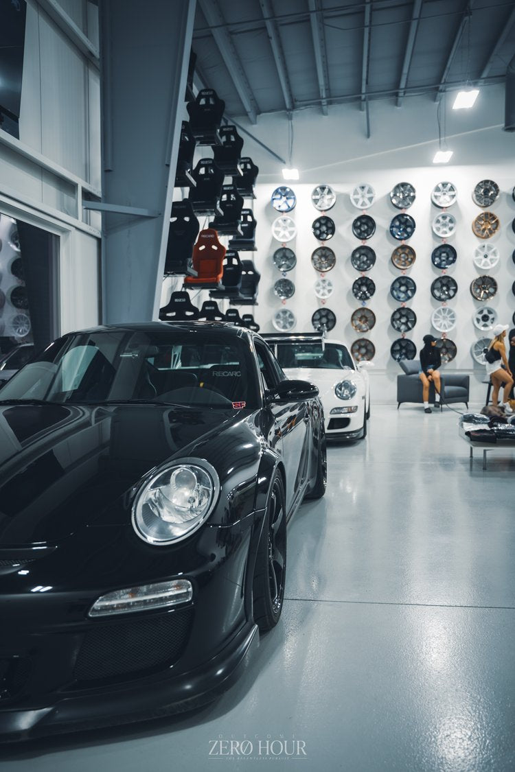 Black Porsche in front of the wheel wall at Speed Factor Calgary