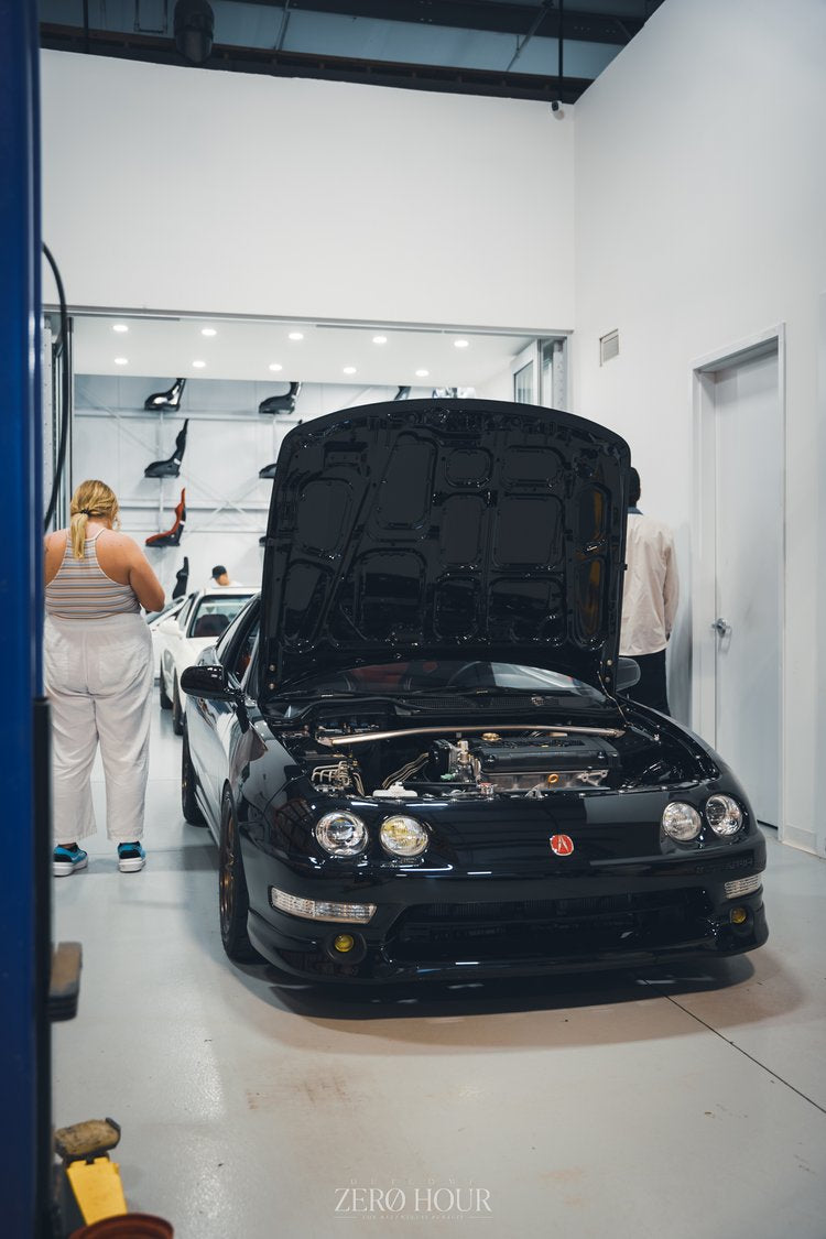 Honda Integra with its hood open at Speed Factor Calgary