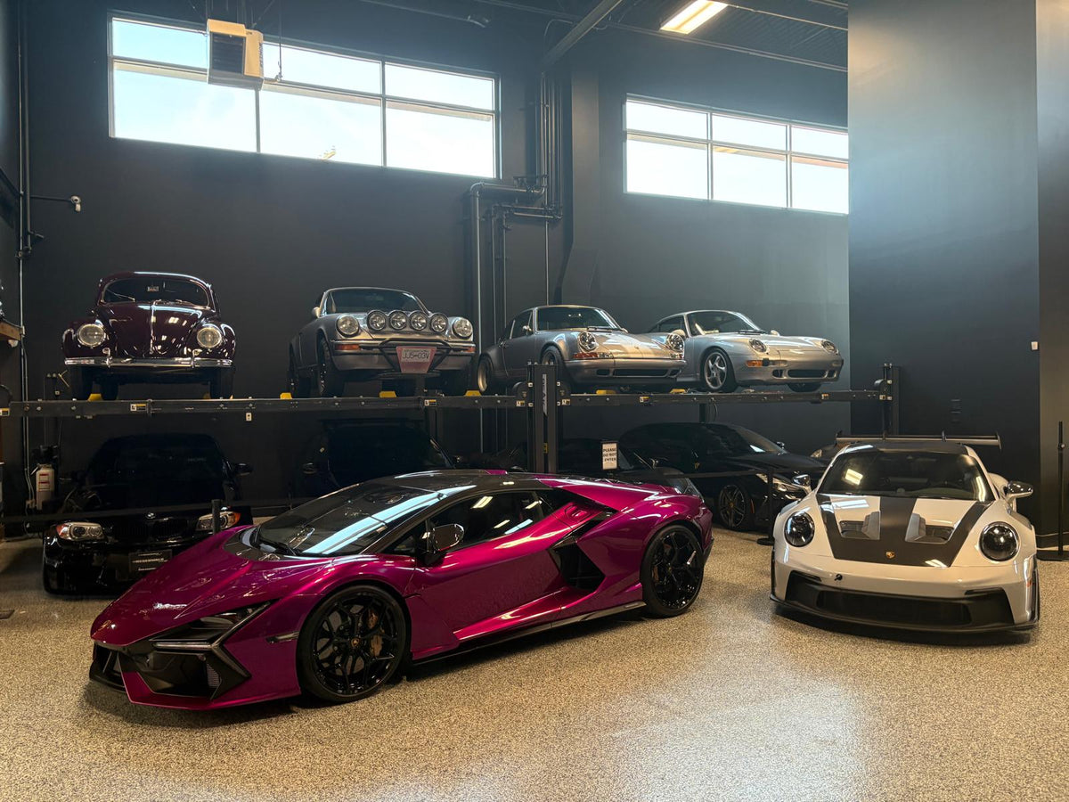 Customer cars inside the Speed Factor showroom under bright shop lighting
